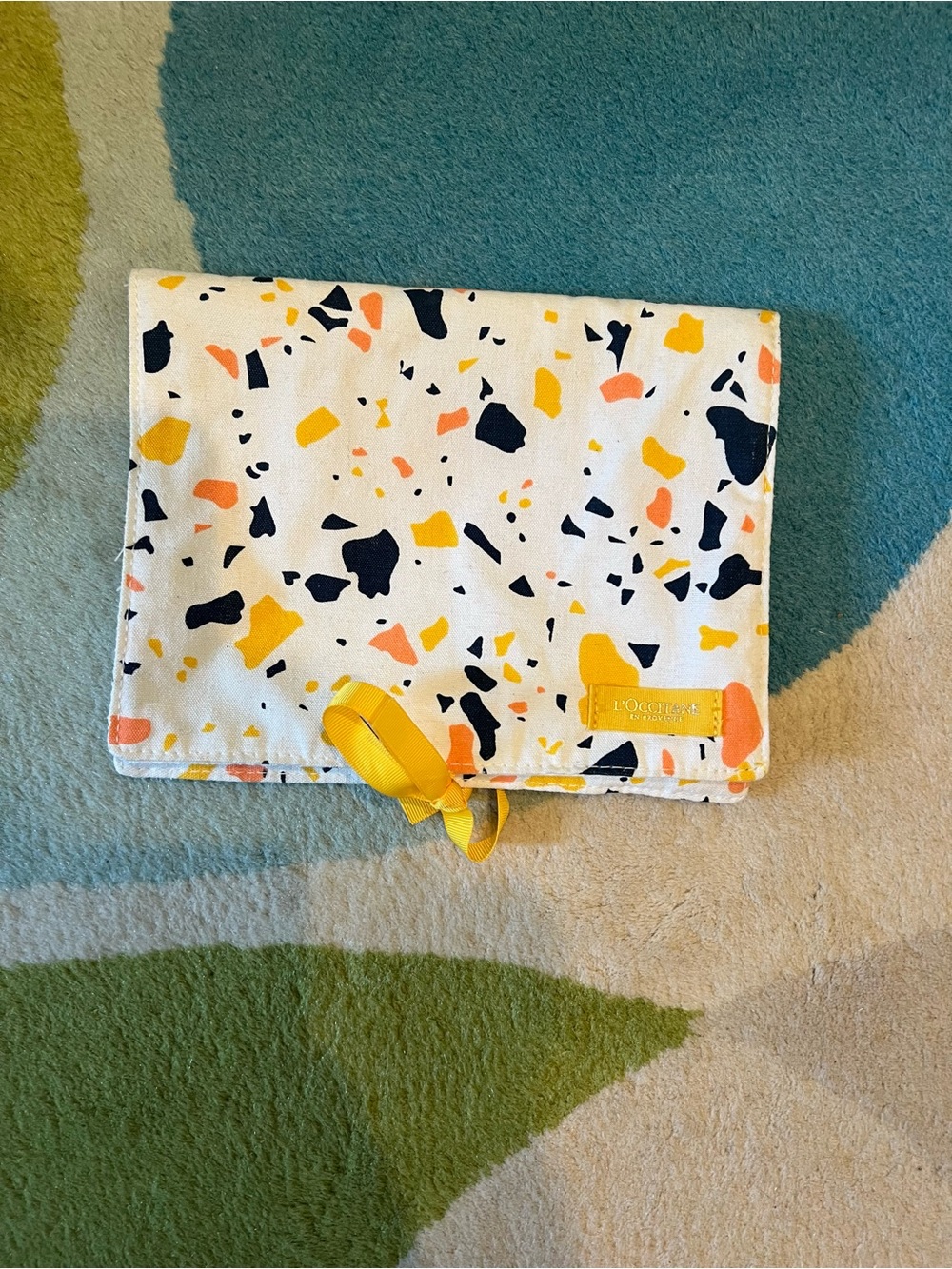 L'Occitane White Terrazzo Print Travel Pouch with Yellow Ribbon